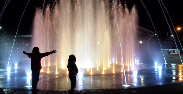 a group of people enjoying time near a fountain